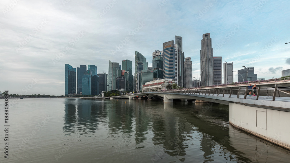 Naklejka premium Esplanade bridge and downtown core skyscrapers in the background Singapore night to day timelapse