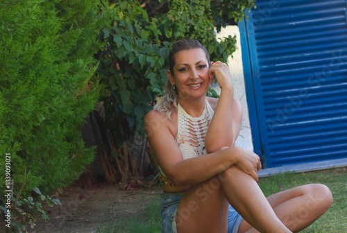 portrait of a beautiful young woman smiling at camera in the garden