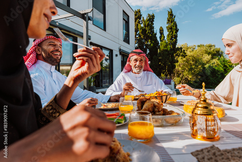 Wallpaper Mural Arab multigenerational family enjoying outdoor meal together Torontodigital.ca