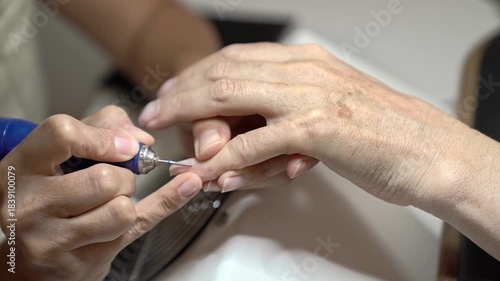 Guide to Classic French Manicure for Mature Hands With Modern Tools. Nail treatment with milling cutter