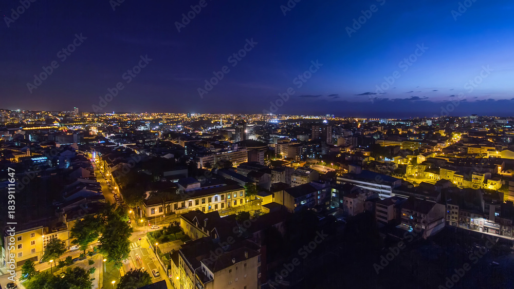 Obraz premium Rooftops of Porto's old town on a warm spring evening timelapse day to night, Porto, Portugal