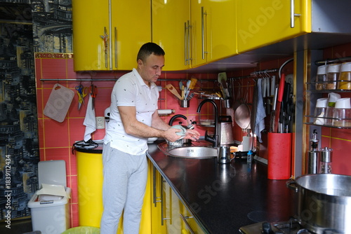 man washes a dishes, close-up of hands and sponge. High quality 4k footage
