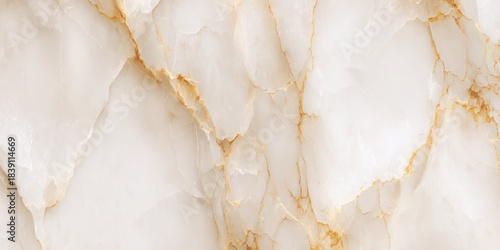 Luxurious polished onyx marble texture with golden veins, creamy white stone surface featuring a creamy white and pale beige background.