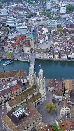 Stunning vertical 4K drone video of Zurich Old Town. Features Grossmünster and Fraumünster churches, Limmat River, and historic cityscape. Perfect for mobile travel content and social media footage.