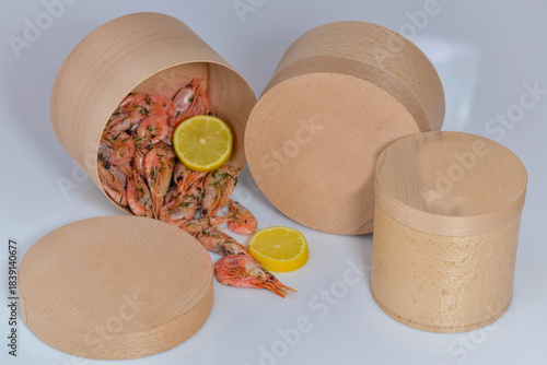 three delivery containers with cooked shrimp on a white background