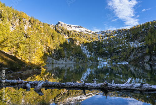 Lago di Sfii in the autumn colored Ticino mountains, Switzerland.