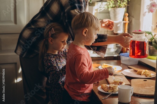 Children preparing breakfast with parent at home