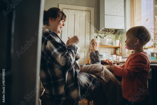 фотографія Mother and children laughing, sharing honest home moments