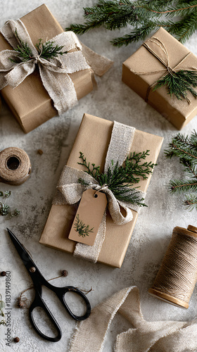 Neutral Eco-Friendly Holiday Gift Wrapping Flat Lay with Kraft Paper, Twine and Evergreen on Light Textured Background