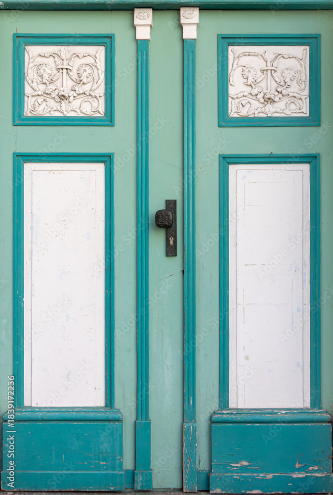 Naklejka premium Mint doors with white stucco on historic facade. Turquoise decorative doors.