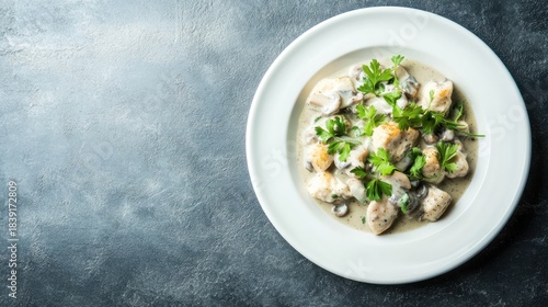Creamy mushroom and chicken dish on white plate