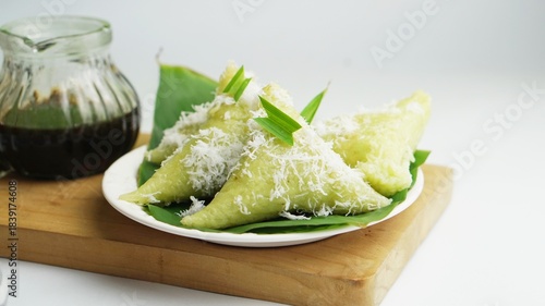 Selected Focus Lupis or Lopis is an Indonesian Traditional Sweet Cake Made of Glutinous Rice, isolated on white background