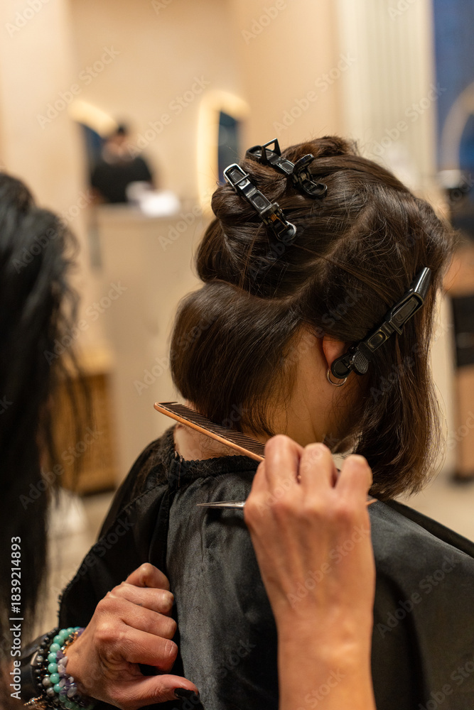 Fototapeta premium Hair Cutting Technique with Sectioned Hair in Salon