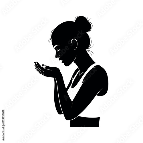 Silhouette of a woman holding something in her hands.