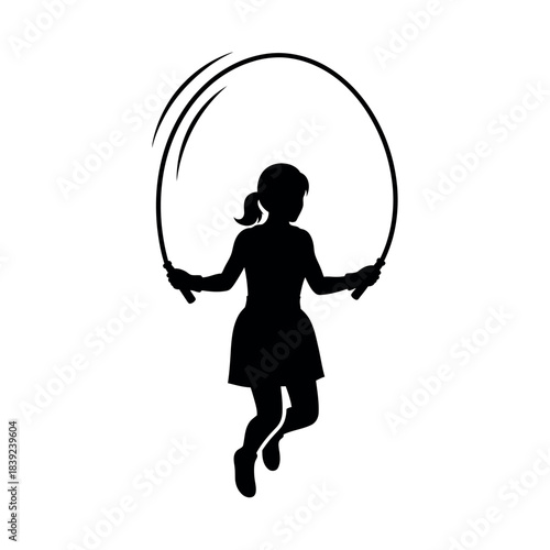 Silhouette of a young girl skipping rope active child playing outdoors.