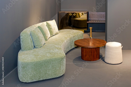 Textile material sofa furniture and wooden table in corner of modern room interior