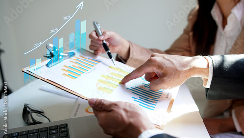 Business people working together discussing plans and discussing financial diagram, Teamwork, Success