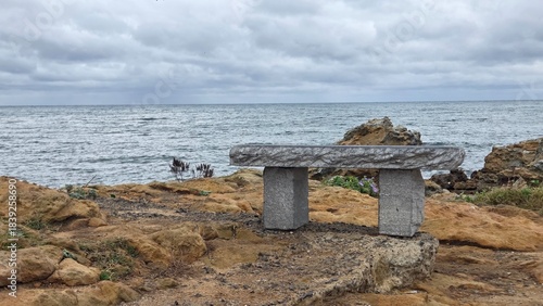 Stone Bench by Rocky Seaside — Calm Coastal Landscape