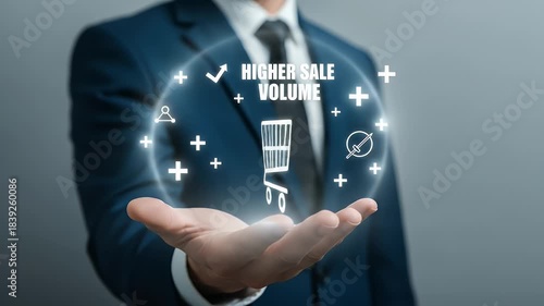Close Up Of Businessman Holding Digital Shopping Cart With Higher Sale Volume In Blue Suit Against Grey Background For Ecommerce And Business Growth