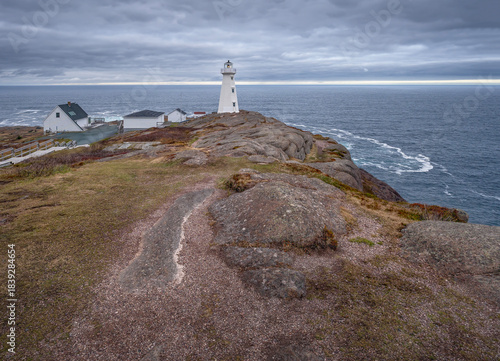 Buildings and lighthouse on the rocky shore of Cape Spear, Newfoundland and Labrador, Canada
