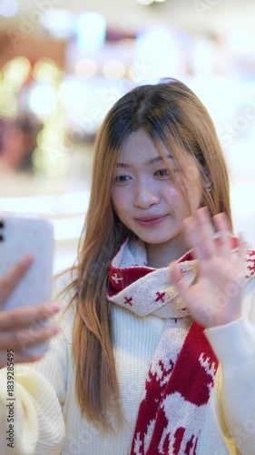  A young woman is happily using her phone at night.