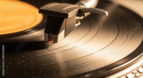 Record player's cartridge and needle tracking the intricate grooves of a classic black vinyl album disk in warm light.