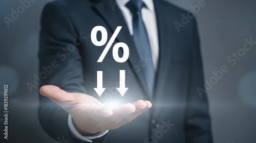 Lowering Percentage Rate Displayed On Hand Of Businessman Wearing Dark Blue Suit In Blurry Background