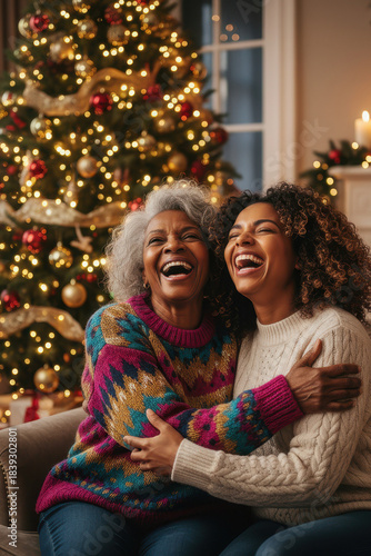 A happy african american family celebrates Christmas. A young black daughter hugs her elderly gray-haired mother next to the Christmas tree.	