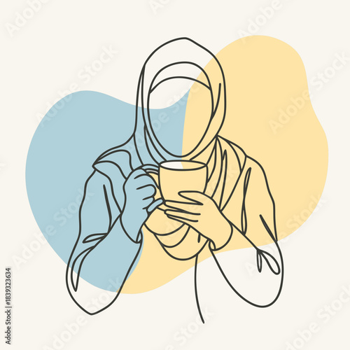 Woman wearing hijab holding a cup of tea