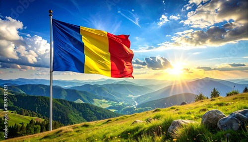 Tricolor flag waving on a hilltop meadow with sunlit mountain views and brilliant blue sky and clouds