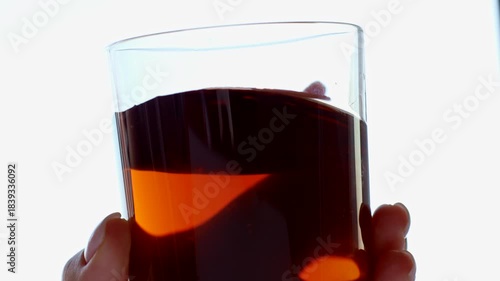 Female hand holding whiskey glass close up