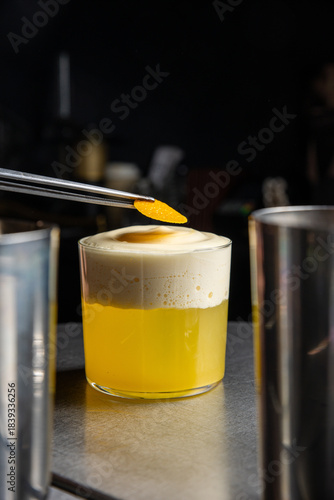 A delicious alcoholic cocktail at the bar. The bartender prepares cocktails