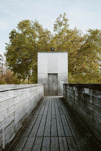 A wide Paris road showcases urban architecture and city mobility through modern exterior light, empty street depth and pavement geometry shaping the quiet atmosphere