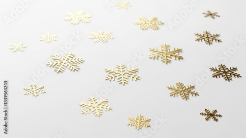 Golden Snowflakes on a White Canvas: A delicate assortment of shimmering gold snowflakes elegantly scattered on a pristine canvas.