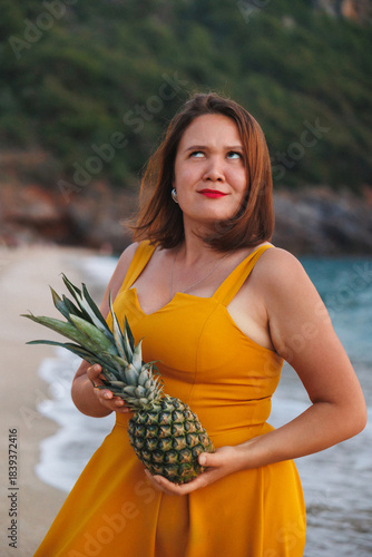 Closeup Woman Holding Pineapple Looking Upward, Vibrant Yellow Dress, Soft Natural Light, Textured Skin, Warm