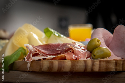 cheese board with prosciutto, cheese and olives