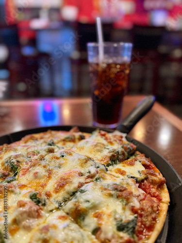Enjoying Pizza and Soda at a Pub Bar in the Evening