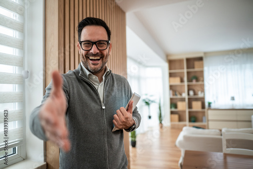 Canvas Print Businessman offering handshake, greeting client in modern home