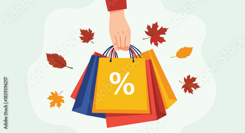 A hand holds colorful shopping bags with a percentage sign during an autumn sale with falling maple leaves in the background.
