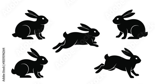 A set of five black rabbit silhouettes in various poses including sitting and running for an easter or nature theme design.