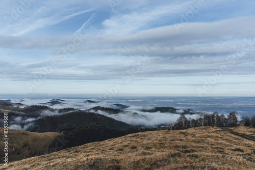 low clouds over the mountains in cold winter with hills 