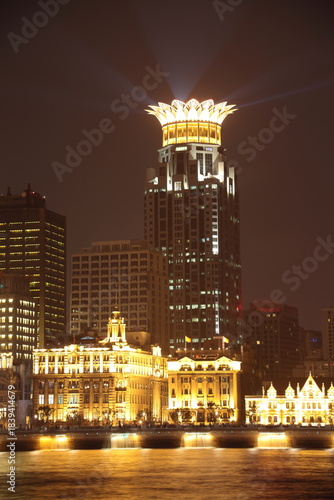 Night view of Shanghai Waitan Skyscrapers with bund center building along Huangpu river in Shanghai, China.
