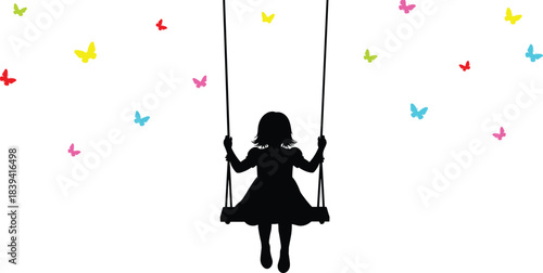Happy little girl silhouette swinging freely surrounded by colorful butterflies in dreamy childhood moment of innocence joy imagination and wonder