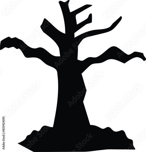 Spooky black silhouette of a barren dead tree with gnarled branches on a mound