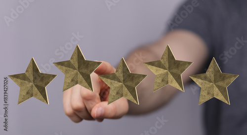 Hand pointing to five star ...