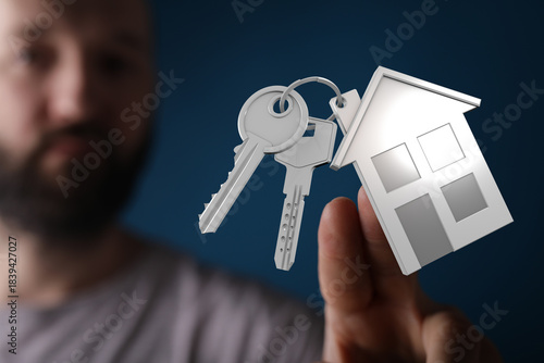 A man is holding a model ho...
