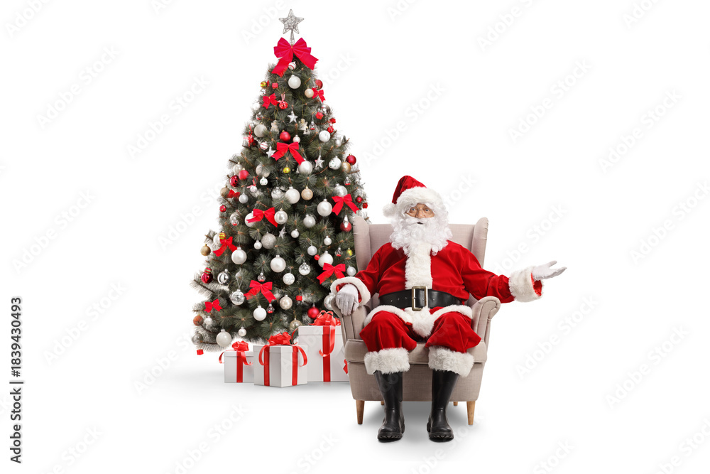 Obraz premium Santa claus sitting in armchair in front of a decorated christmas tree