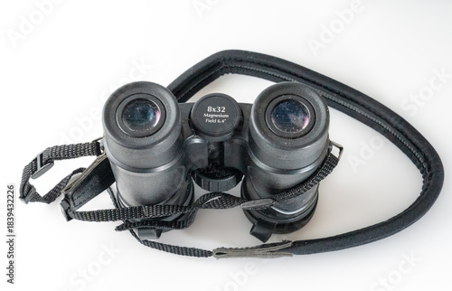 field gllasses binoculars with neck strap isolated on a white background