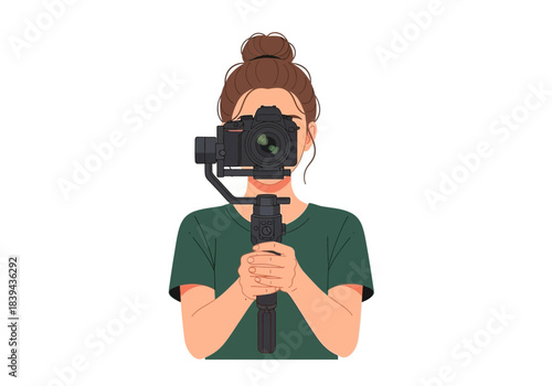 Woman with hair in a bun holding a professional camera on a gimbal stabilizer, closeup