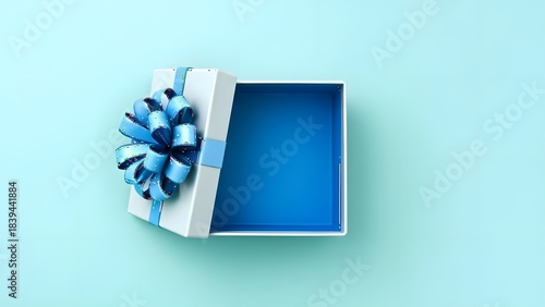 Open gift box with blue ribbon on light background